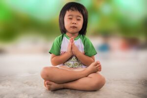 young child praying or meditating